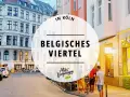 Abendstimmung im belgischen Viertel in Köln. Menschen sitzen vor einem beleuchteten Restaurant, Autos parken am Straßenrand.