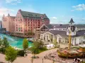 Ein malerischer Kanal fließt vorbei an bunten Gebäuden und einem alten Schiff. Das ist das charmante Themenhotel im Europa-Park.