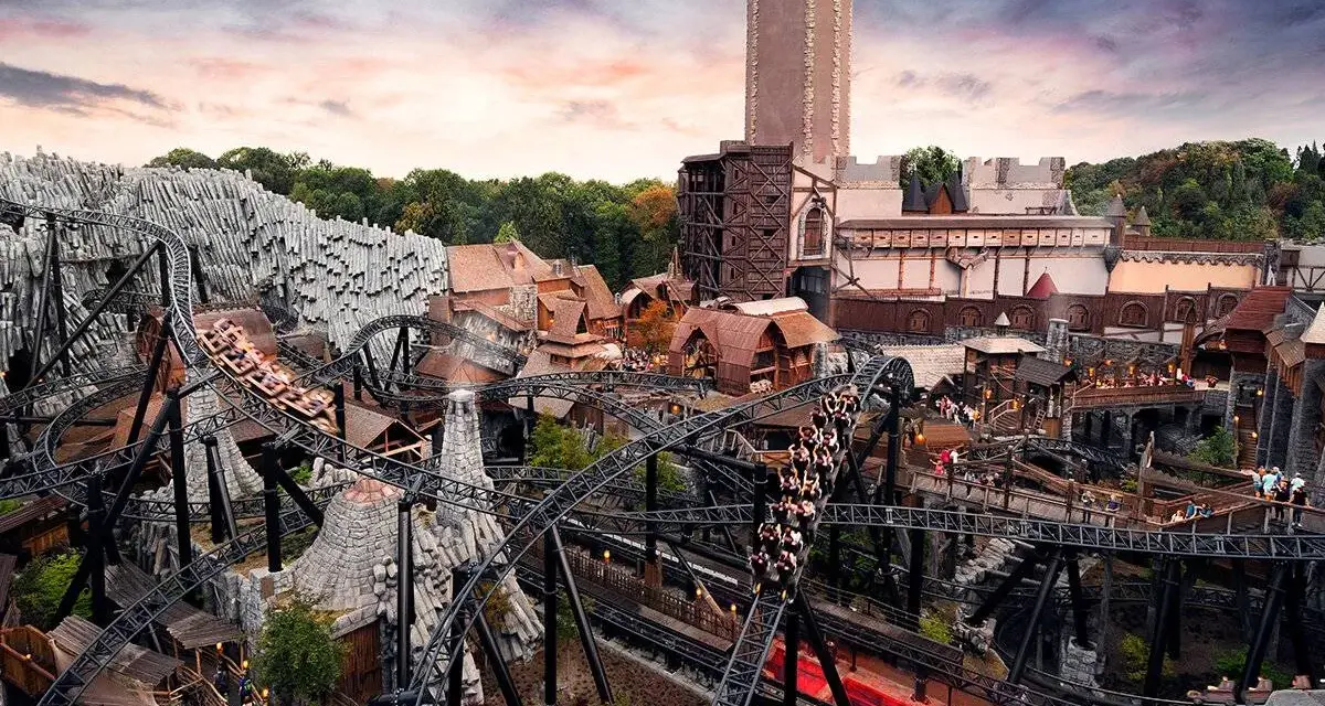 Achtung, **Phantasialand Geburtstagskinder**! Die Achterbahn rast durch eine mittelalterliche Kulisse mit Burg und Felsen.
