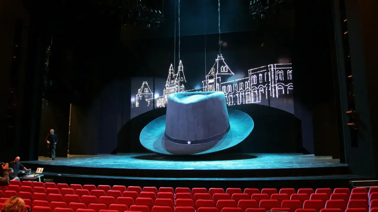 B&uuml;hne mit riesigem Hut und Stadtkulisse, bereit f&uuml;r Musicals in Deutschland.